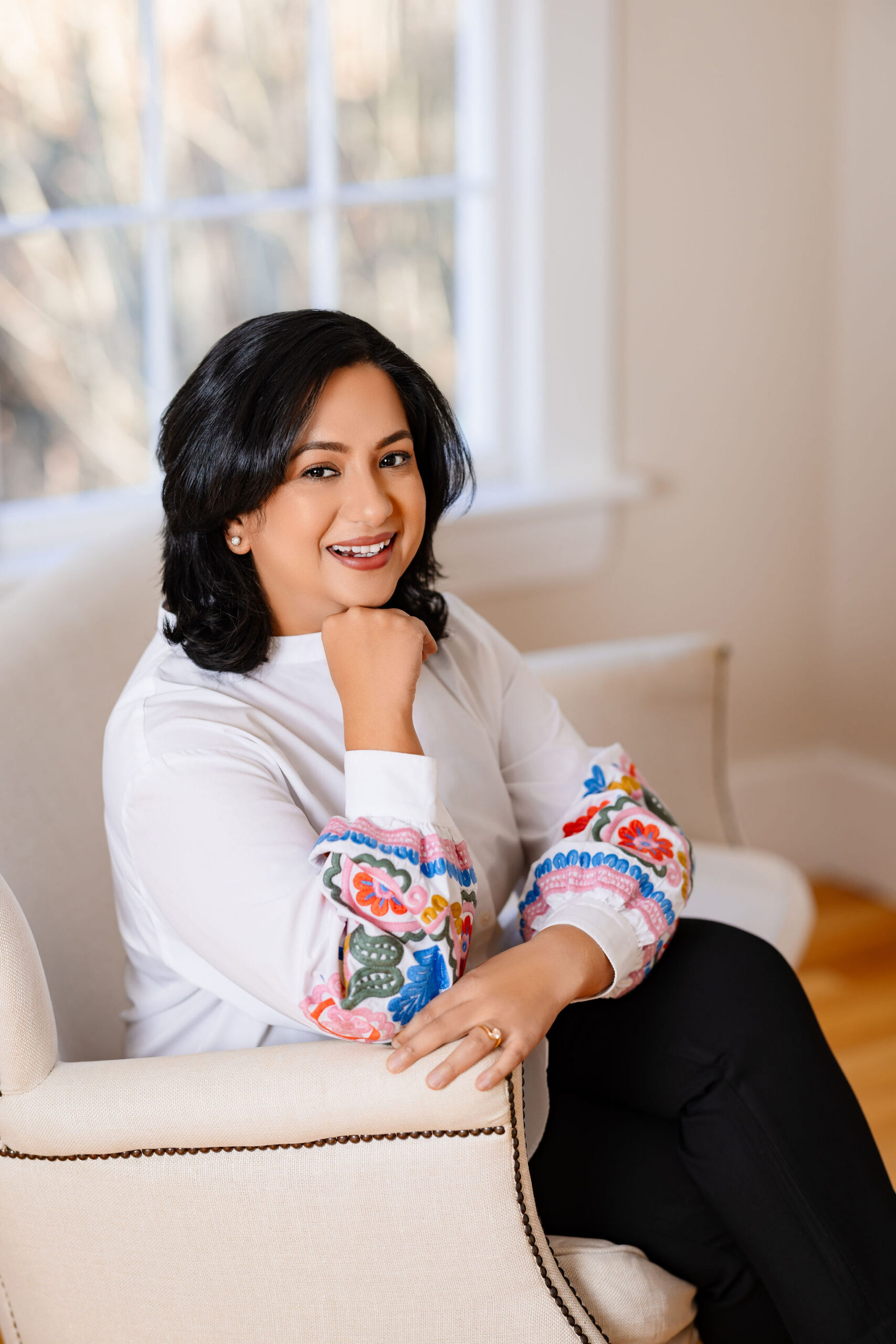 Avani Jain, founder of Think Bold Marketing, smiling in a seated portrait